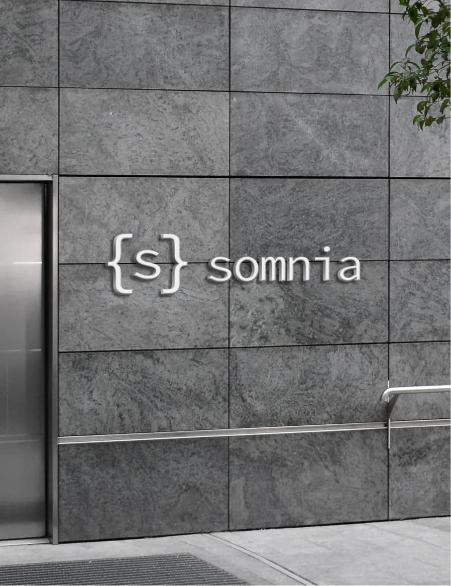 Somnia lettered on a stone wall by a lift