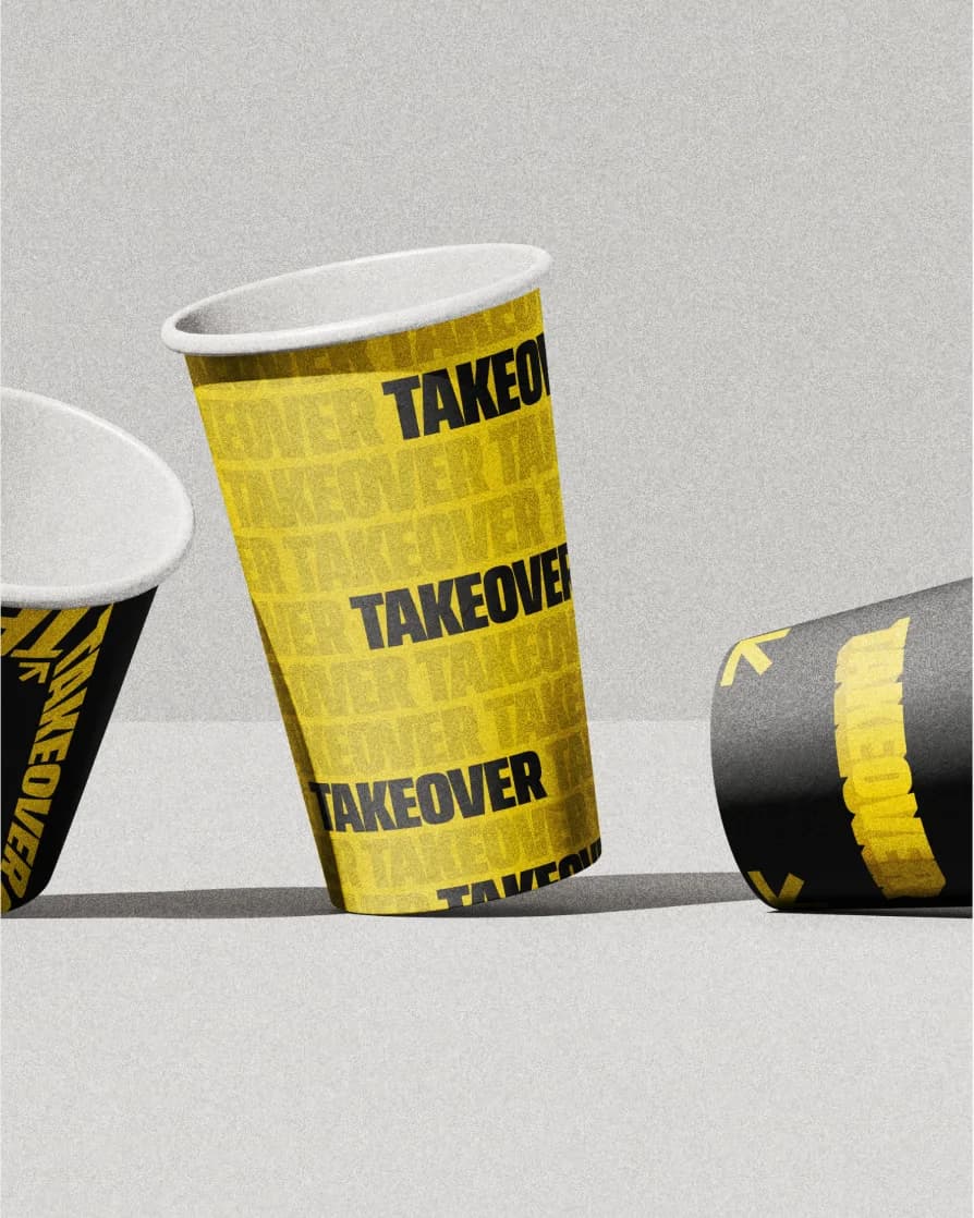 Yellow and black Takeover paper cups