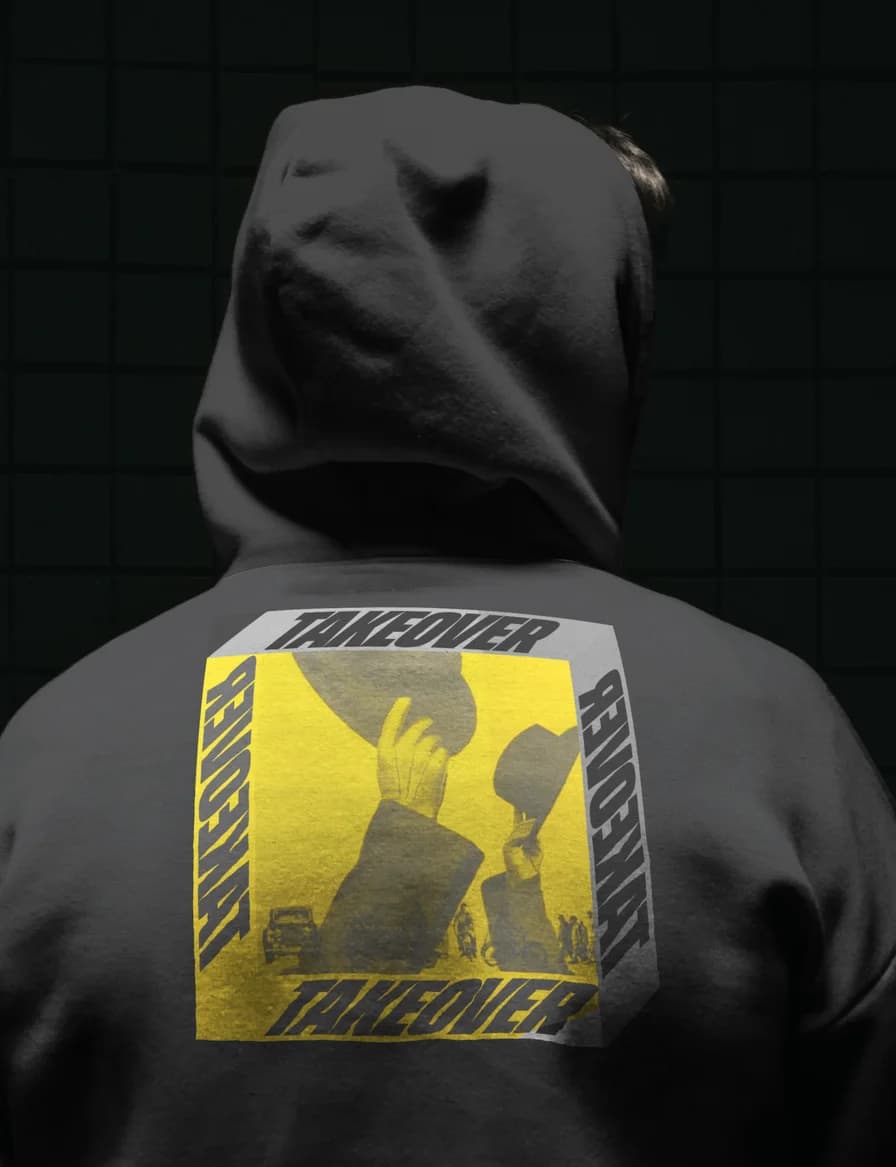 The back of a grey hoodie with a Takeover print