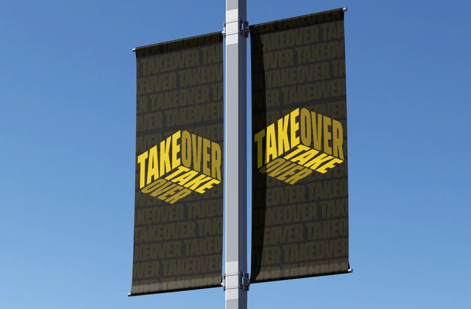 Two Takeover banners on a lamp post against a blue sky