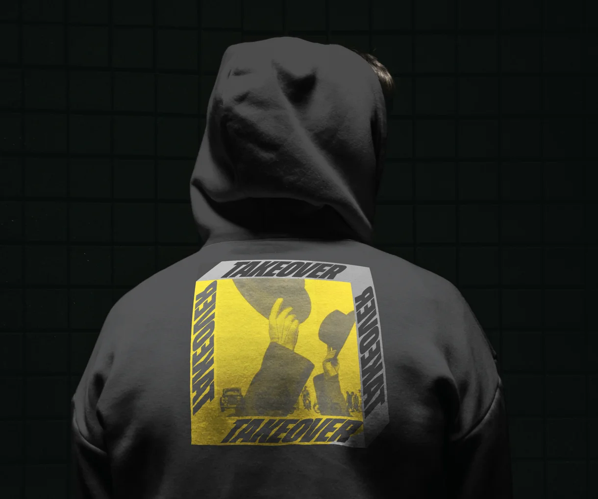 The back of a grey hoodie with a Takeover print