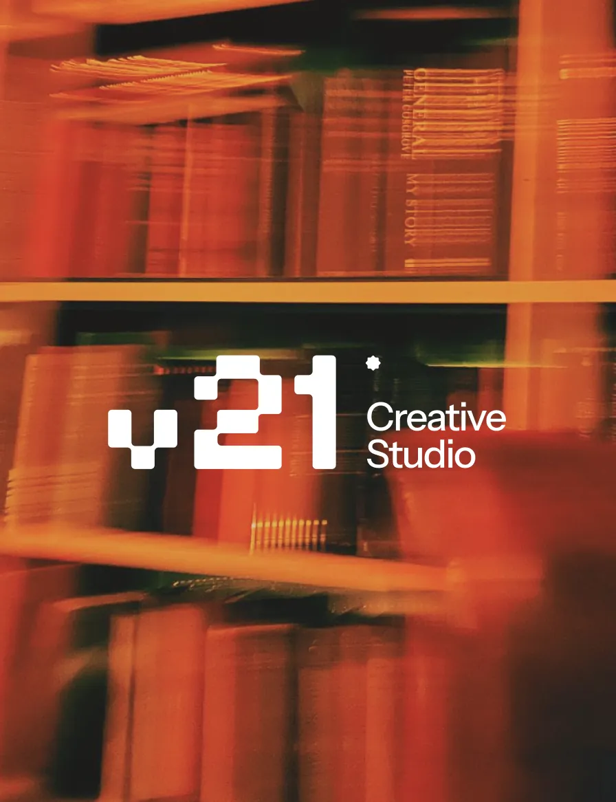 V21 Creative Studio over a blurred bookshelf