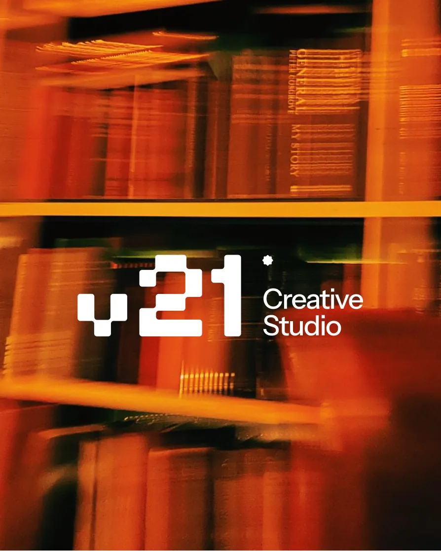 V21 Creative Studio over a blurred bookshelf