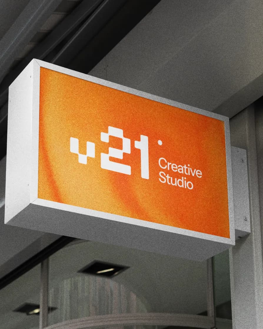 Orange V21 lightbox sign over a shop front